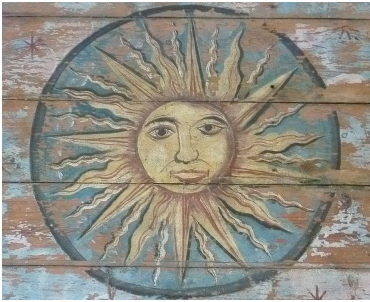 18th century ceiling painting of the Sun, with a human style face